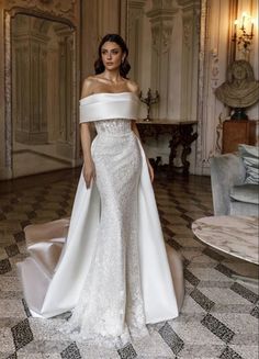 a woman in a white wedding dress posing for the camera with her hand on her hip