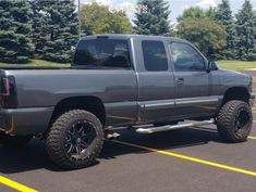 a gray truck parked in a parking lot