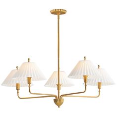 a brass chandelier with five white shades