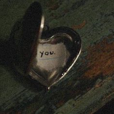 a heart shaped object with the word you written on it