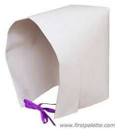 an open white paper bag with purple handles on the inside and outside, sitting in front of a white background