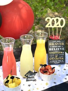 a table topped with drinks and desserts