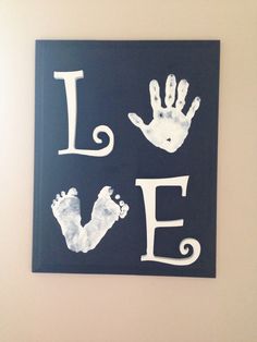 two handprints on a wall with the word love spelled in white and black