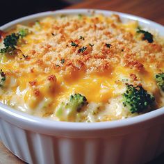 broccoli and cheese casserole in a white dish on a wooden table