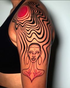 a woman's arm with an abstract tattoo design on her left shoulder and breast