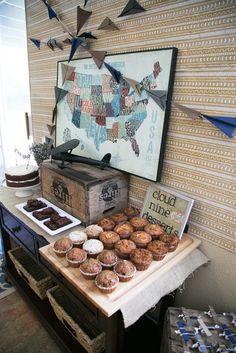 a table topped with lots of pastries next to a map