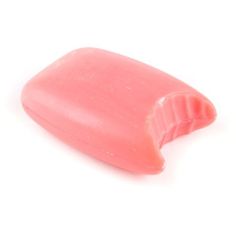 a pink soap bar sitting on top of a white surface