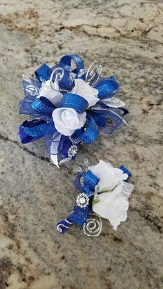 two blue and white flowers on a marble surface