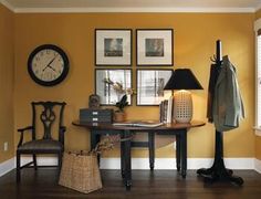 a room with yellow walls and pictures on the wall