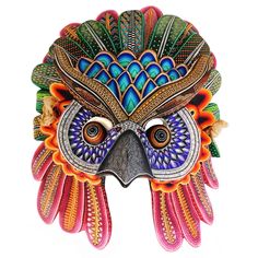 an owl mask with colorful feathers on it's face is featured against a white background