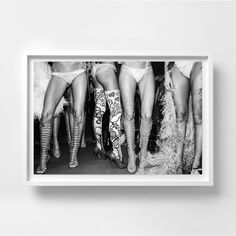 black and white photograph of women in high heeled boots with their legs spread out