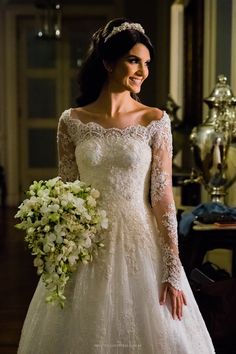 a woman in a wedding dress holding a bouquet