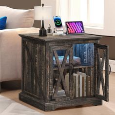 an end table with books and electronics on it