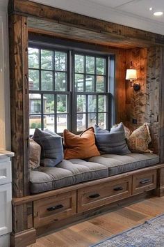 a living room filled with lots of furniture next to a large window covered in wooden planks