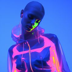 a woman with neon lights on her face and body, wearing a hoodie jacket