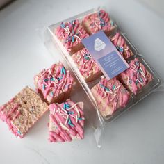 several pieces of cake with sprinkles in a plastic container on a table