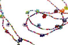 Add colorful floral fun to your outfits with this charming necklace featuring hand-beaded flowers all along its generous, stretchy 28" length! Vibrant multicolored glass beads form little flowers and add delicate, yet eye-grabbing style as they dangle! And perhaps buy a couple chains at a discount to double the floral loveliness! Beaded Flower Necklace (elasticized cord), 28" long, flowers 1/4" diameter MANY ARTFUL ITEMS ARE AVAILABLE IN MY SHOP! VISIT MY SHOP GODDESS ARTS COLLECTION www.etsy.com/shop/goddessartcollection                         SPECIAL SHIPPING RATES!!                         FREE US SHIPPING(certain items excluded)                         REDUCED INTERNATIONAL & CANADA  **CUSTOM ORDERS WELCOMED** Put my brush and skill to work for you! simply contact me with any ideas or Beaded Multicolor Flower Necklace For Beach, Colorful Bead Flower Necklace For Beach, Colorful Beads Flower Necklace For Beach, Colorful Beaded Jewelry For Spring, Spring Beaded Flower Necklace With Round Beads, Multicolor Flower Jewelry For Beach, Multicolor Flower Shaped Jewelry For Summer, Multicolor Flower-shaped Jewelry For Summer, Multicolor Flower Necklace For Summer Beach