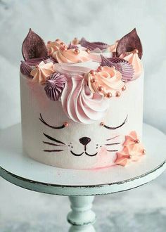 a white cake with pink frosting and flowers on top