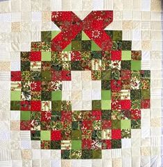 a quilted christmas ornament with red, green and white squares