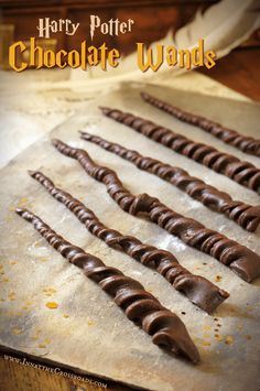 chocolate wands are lined up on a baking sheet with the title harry potter chocolate wands