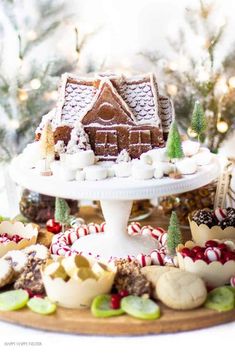 a platter filled with cookies and other holiday treats on top of a white table