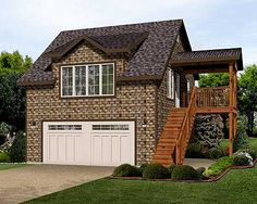 a two story brick house with a garage and stairs leading up to the second floor