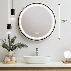 a bathroom with a sink, mirror and plant on the counter top next to it