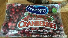 a bag of cranberries sitting on top of a wooden table