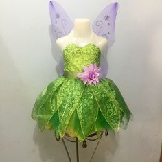 a green and purple fairy dress on top of a mannequin