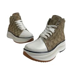 New With Tags, Manmade Women's Lace Up Chunky High Top Print Micha Platform Sneakers In Size 6. Brown And White In Color, Made From Textile And Pvc. Both The Inner And Outer Soles Are Flawless. Original Box Not Included. Brand: Manmade Size: 6 Color: Brown, White Style: High Top Platform Sneakers Material: Textile, Pvc For: Women Measurements: Heel 2 In / 5 Cm Shaft Height 4 In / 10 Cm White Sole Wedge Sneakers With Round Toe, Trendy High-top Canvas Shoes With Textured Sole, White Leather Round Toe Wedge Sneakers, White High-top Wedge Sneakers With Lug Sole, Trendy High-top Sneakers With Branded Insole, Trendy Beige High-top Platform Sneakers, White Wedge Sneakers With Contrast Sole And Round Toe, Trendy Wedge Sneakers With Contrast Sole, Trendy Wedge Sneakers With Lug Sole And Round Toe