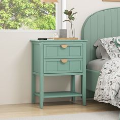 a bedroom with a bed, nightstand and green headboard on the side of the bed