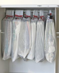 the closet is filled with plastic bags and other items to keep things organized on it