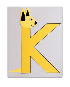 the letter k is made up of paper with a dog's head sticking out of it