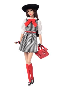 a doll is holding a red purse and wearing a black hat