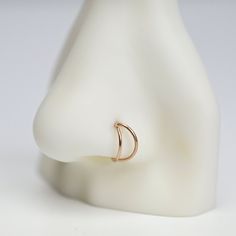 a close up of a ring on a mannequin's head with a white background