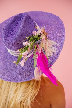 Add a pop of color with our Purple Haze sun hat. The playful ribbon band, adorned with white and pink feathers and pink flowers, will make you feel like a Derby winner. Keep the sun out of your eyes and your style on point with this quirky hat. This hat is ONE OF A KIND, created by our owner Stephanie. To receive item quicker, expedited shipping is available at checkout. Pink Bohemian Sun Hat For Garden Party, Bohemian Pink Sun Hat For Garden Party, Spring Party Fedora Panama Hat, Summer Panama Hat For Spring Parties, Pink Mini Hat With Feather Trim For Summer, Bohemian Sun Hat For Spring Party, Summer Mini Hats With Feathers, Summer Whimsical Hat With Curved Brim, Whimsical Summer Hat With Curved Brim