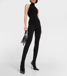 Halterneck Stirrup Catsuit in Black - Norma Kamali | Mytheresa High Neck High Stretch Elastane Unitard, High Stretch Full Length Elastane Unitard, High Neck Elastane Bodysuit For Party, High Neck High Stretch Unitard For Night Out, High Neck Unitard With High Stretch For Night Out, Sleek High Stretch Evening Bodysuit, High Stretch Elastane Bodysuit For Evening, Full-length Tight Elastane Unitard, Elegant High Neck Stretch Jumpsuits And Rompers