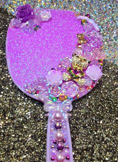 a purple mirror sitting on top of a glitter covered floor