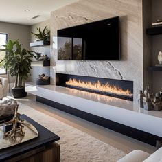 a living room with a large television mounted on the wall and a fire place in front of it