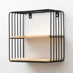 a black metal shelf with two wooden shelves on the top and one is hanging from it's side