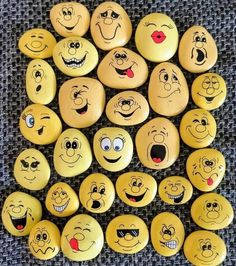 a bunch of smiley face rocks sitting on top of a table