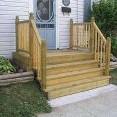 a wooden porch with steps leading up to the front door