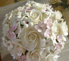 a bridal bouquet with white and pink flowers