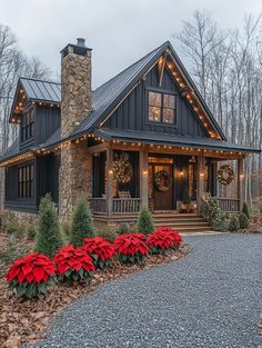 a house with christmas lights and poinsettis on the front porch is shown