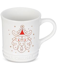 a white mug with a red and gold christmas tree on it