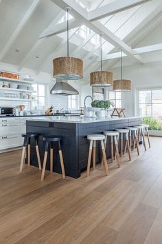 a kitchen with an island and several stools