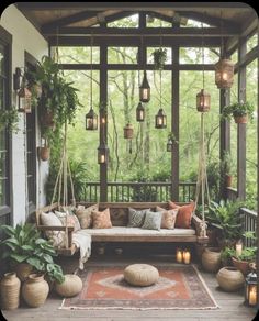 a porch covered in lots of plants and hanging lights