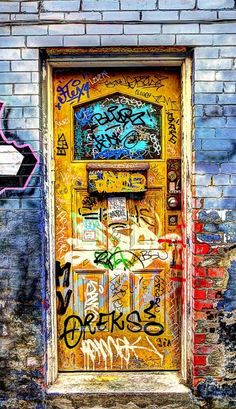 an old door with some graffiti on it