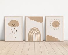 three children's wall art prints with clouds, rainbows and sun on them