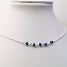 Short silver necklace with dark blue Lapis Lazuli beads.  Lapis Lazuli is a September birthstone. Lapis Lazuli is associated with strength and courage, royalty, intellect, wisdom and truth. The necklace is made to order so please allow 7 days for processing.  *Material - sterling silver and natural Lapis lazuli gemstones, *Necklace length - 42 cm *       Diameter of Lapis lazuli beads - 3,4 mm *Handmade in Sweden, each piece is unique Packaging The jewelry comes in a gift box Shipping  *Free shipping Jewelry care *Jewelry should not be exposed to creams/lotions, sprays or perfume *Remove jewelry before showering and swimming *Keep your jewelry clean and dry Visit Katrosi Jewelry's website https://katrosi.com for more information. Back to the shop https://katrosijewelry.etsy.com Follow @kat Minimalist Blue Beaded Chain Necklaces, Minimalist Blue Beaded Chain Necklace, Blue Minimalist Necklace With Spacer Beads, Blue Minimalist Necklaces With Spacer Beads, Minimalist Blue Necklaces With Spacer Beads, Blue Sterling Silver Necklaces With Tiny Beads, Blue Sterling Silver Necklace With Spacer Beads, Short Silver Necklace, Minimalist Silver Ring